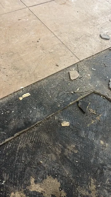 Black bitumen mastic floor removal in a W11 flat